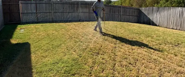 Worker applying lawn disease treatment to a lawn